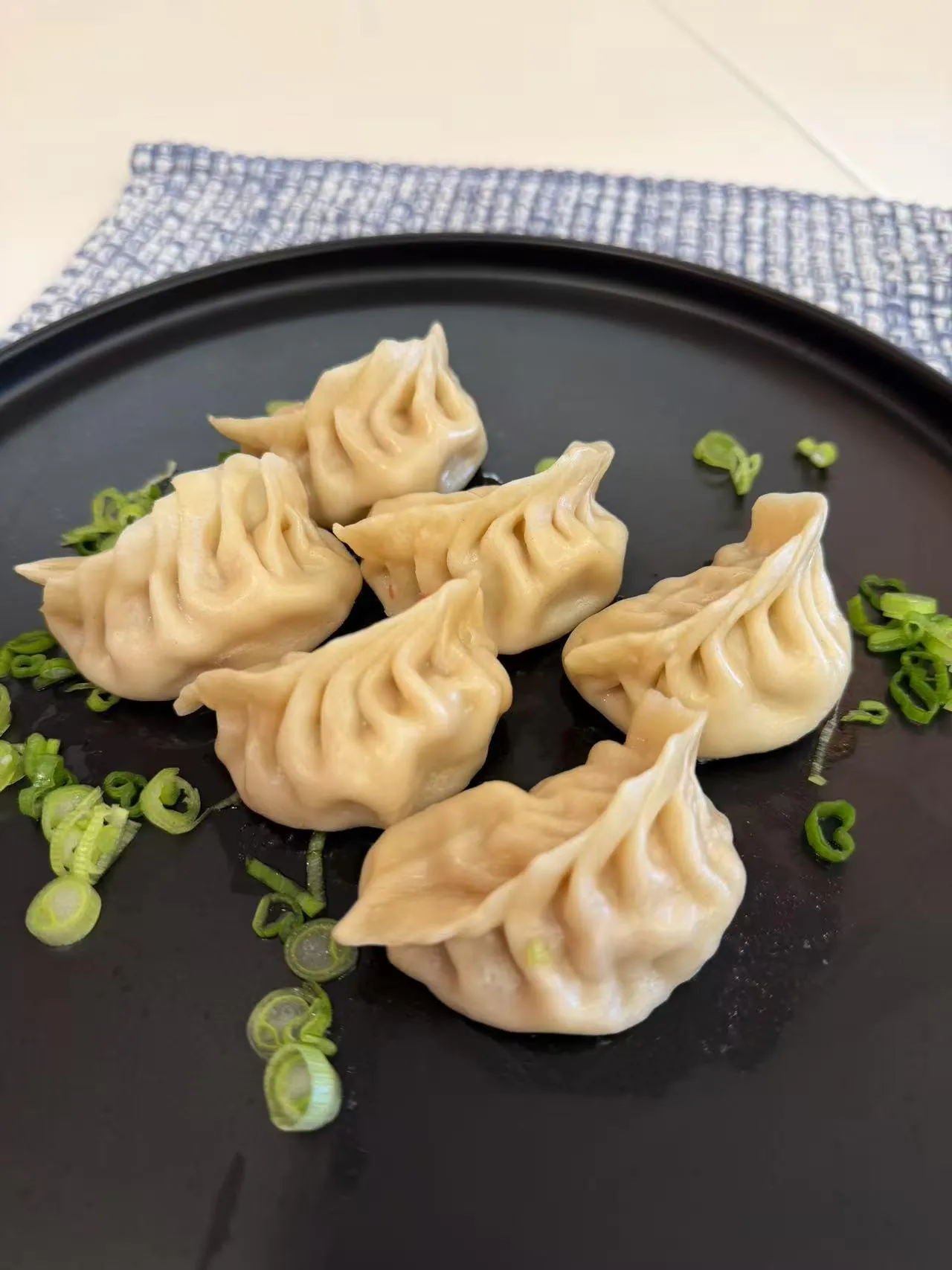 Classic pork steamed dumplings with scallions at Dumpling Station, a Chinese Restaurant in Delaware