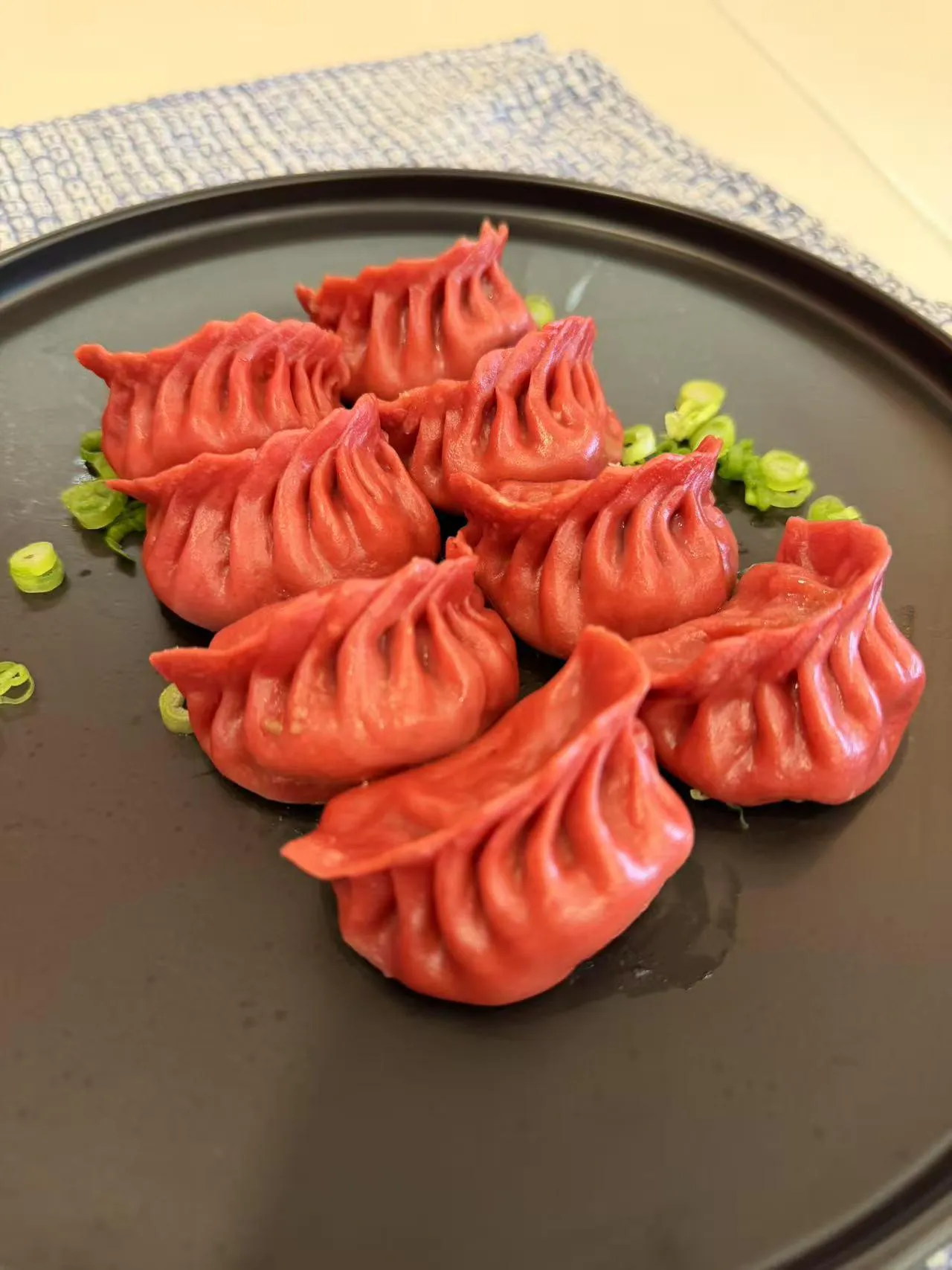 Beet-infused red pork steamed dumplings at Dumpling Station, a Chinese Restaurant in Delaware