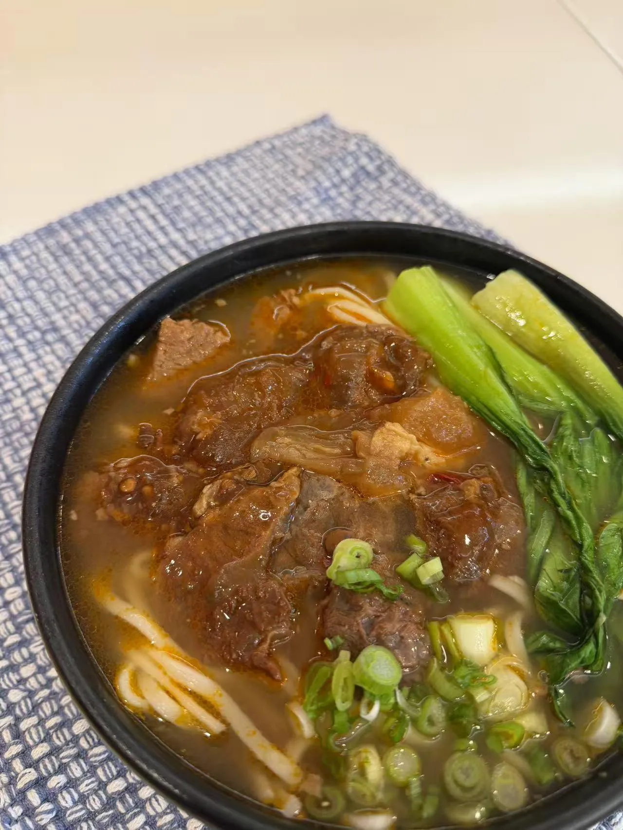 Beef noodle soup with tender meat and greens at Dumpling Station, a Chinese Restaurant in Delaware